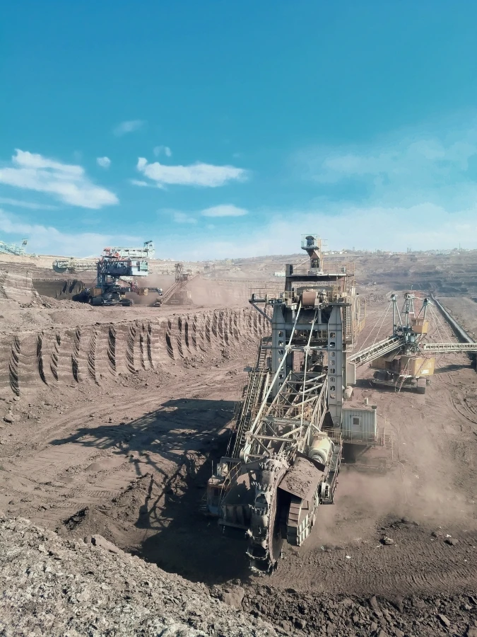 A panoramic shot of mining equipment and conveyors in an open mining field.